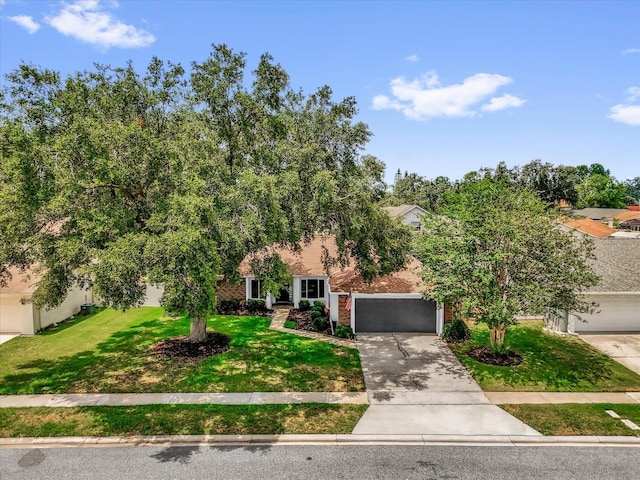 2344 Whispering Maple Dr, Orlando, FL 32837 - view of property hidden behind natural elements featuring an attached garage, driveway, and a front lawn