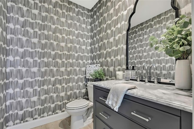 bathroom with tile walls, vanity, and toilet