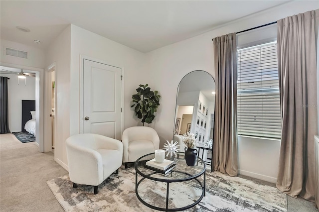 sitting room featuring carpet floors, ceiling fan, and baseboards