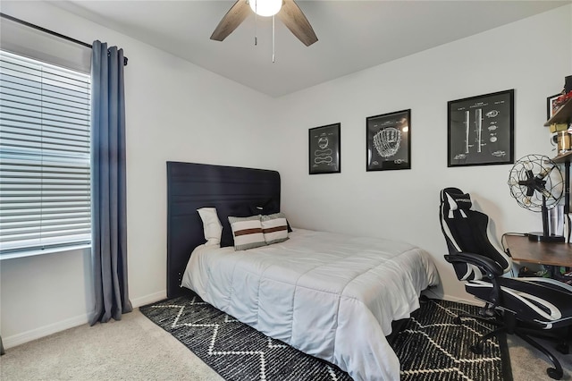 carpeted bedroom featuring baseboards and a ceiling fan