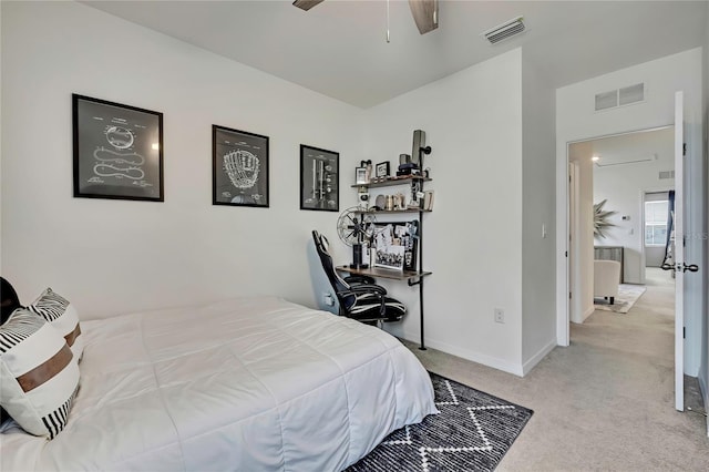 bedroom featuring light colored carpet, baseboards, and a ceiling fan