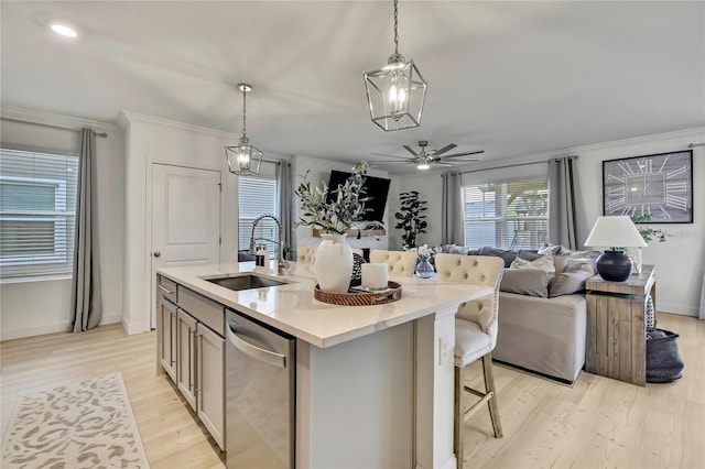 kitchen featuring a sink, stainless steel dishwasher, open floor plan, light wood-type flooring, and light countertops
