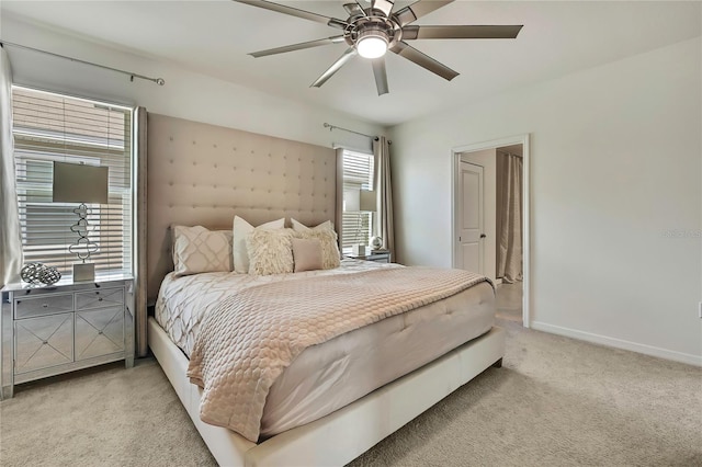 bedroom with light carpet, baseboards, and a ceiling fan