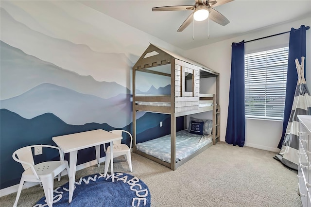 carpeted bedroom featuring baseboards and ceiling fan