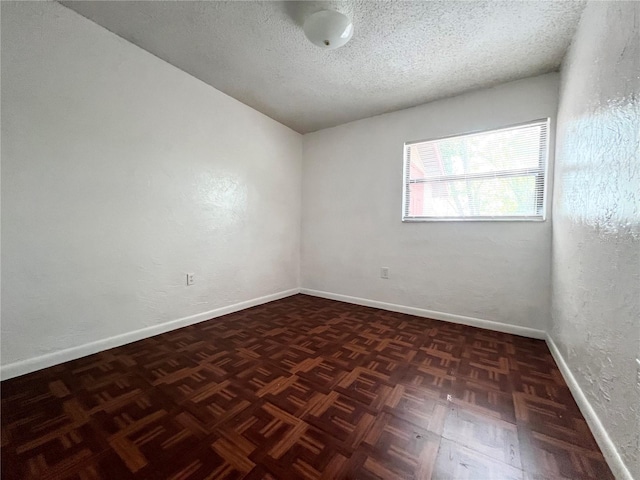 501 Las Palmas Cir Unit 676, Avon Park, FL 33825 - spare room featuring baseboards, a textured ceiling, and a textured wall