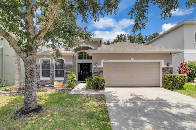 10293 Cypress Knee Cir, Orlando, FL 32825 - view of front facade featuring stucco siding, stone siding, an attached garage, concrete driveway, and a front lawn