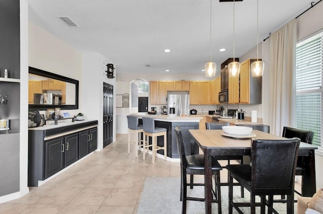 10293 Cypress Knee Cir, Orlando, FL 32825 - dining area featuring recessed lighting, light tile patterned floors, and arched walkways