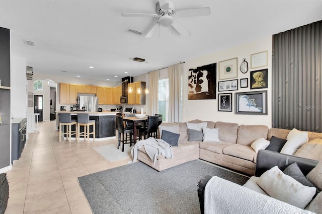 10293 Cypress Knee Cir, Orlando, FL 32825 - living room featuring a ceiling fan, arched walkways, light tile patterned floors, and recessed lighting