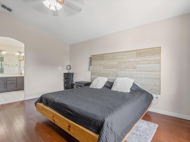 437 Bridgewater Ct, Kissimmee, FL 34758 - bedroom with light wood finished floors, baseboards, ensuite bath, and a ceiling fan