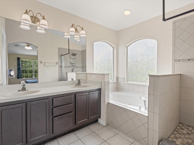 437 Bridgewater Ct, Kissimmee, FL 34758 - bathroom with walk in shower, a jetted tub, double vanity, tile patterned floors, and ceiling fan