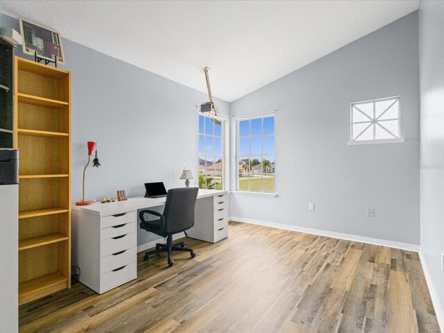 437 Bridgewater Ct, Kissimmee, FL 34758 - office with wood finished floors, vaulted ceiling, and baseboards