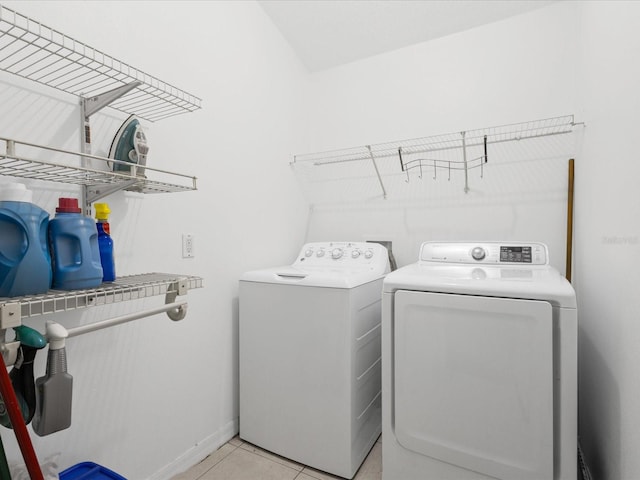 437 Bridgewater Ct, Kissimmee, FL 34758 - washroom featuring washer and clothes dryer, light tile patterned flooring, and baseboards