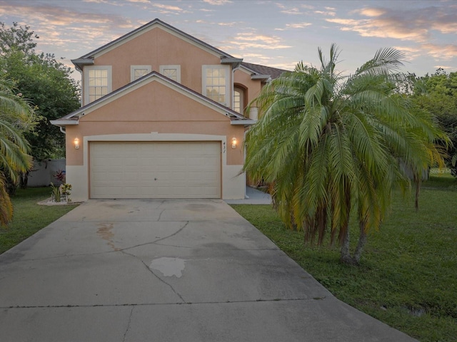 437 Bridgewater Ct, Kissimmee, FL 34758 - traditional-style home with stucco siding, concrete driveway, and a lawn