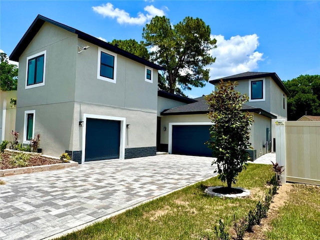 107 Grove St, Orlando, FL 32835 - view of front of house featuring decorative driveway and stucco siding