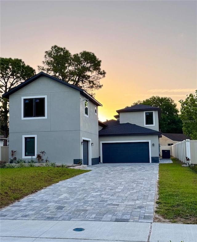 107 Grove St, Orlando, FL 32835 - view of front of home with stucco siding, decorative driveway, and an attached garage