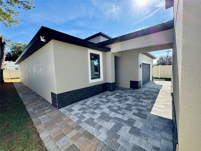 107 Grove St, Orlando, FL 32835 - view of side of property with stucco siding and an attached garage