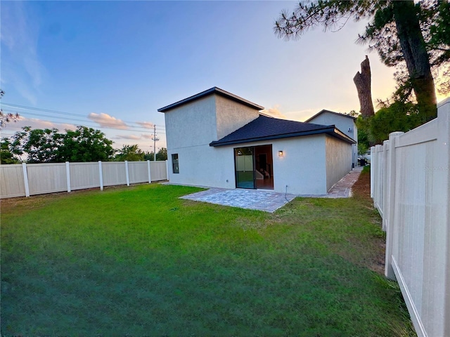 107 Grove St, Orlando, FL 32835 - back of house at dusk with a patio area and stucco siding