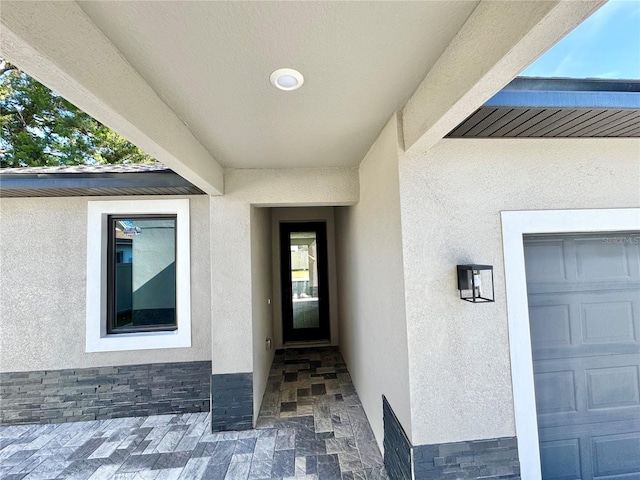 107 Grove St, Orlando, FL 32835 - doorway to property with stucco siding and a garage