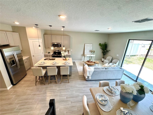 107 Grove St, Orlando, FL 32835 - living area with a textured ceiling, wood tiled floors, and baseboards