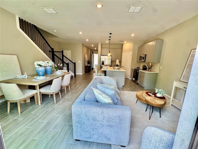 107 Grove St, Orlando, FL 32835 - living area with stairway, wood finish floors, recessed lighting, and baseboards