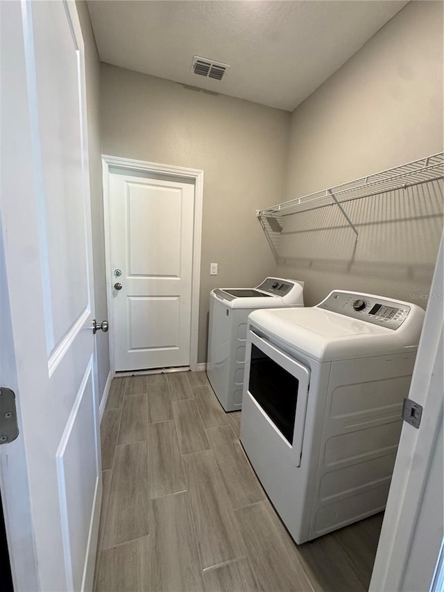 107 Grove St, Orlando, FL 32835 - washroom featuring washing machine and clothes dryer, wood finish floors, and baseboards