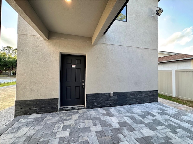 107 Grove St, Orlando, FL 32835 - view of exterior entry featuring stucco siding and a patio area