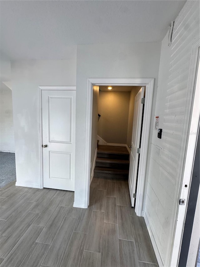 107 Grove St, Orlando, FL 32835 - corridor with wood tiled floors, stairway, and baseboards