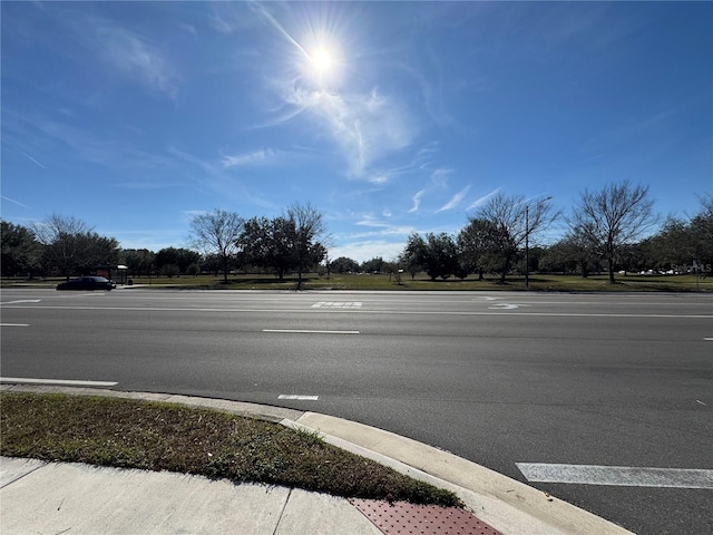 107 Grove St, Orlando, FL 32835 - view of asphalt road featuring curbs and street lights