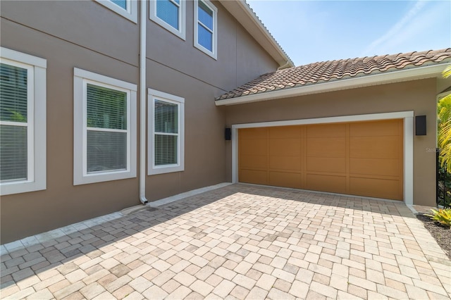 8268 Bellow St, Orlando, FL 32827 - garage featuring decorative driveway