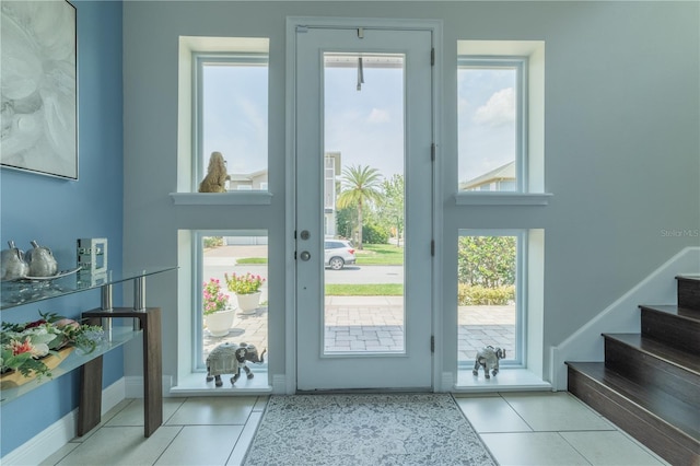 8268 Bellow St, Orlando, FL 32827 - doorway to outside with tile patterned floors, stairs, and baseboards