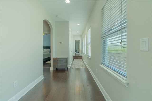 8268 Bellow St, Orlando, FL 32827 - hallway featuring arched walkways, recessed lighting, wood finished floors, and baseboards