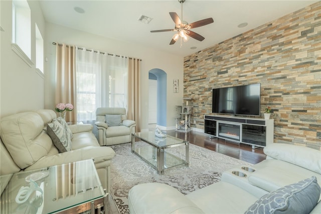 8268 Bellow St, Orlando, FL 32827 - living area with arched walkways, ceiling fan, wood finished floors, and plenty of natural light