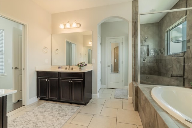 8268 Bellow St, Orlando, FL 32827 - full bathroom with a garden tub, a shower stall, vanity, tile patterned floors, and healthy amount of natural light
