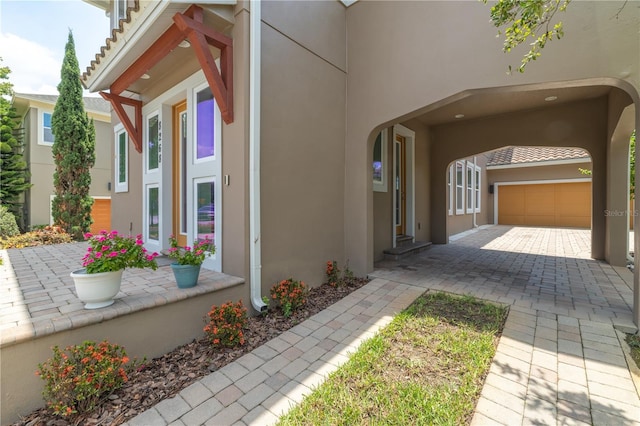 8268 Bellow St, Orlando, FL 32827 - view of home's exterior featuring stucco siding, driveway, and an attached garage