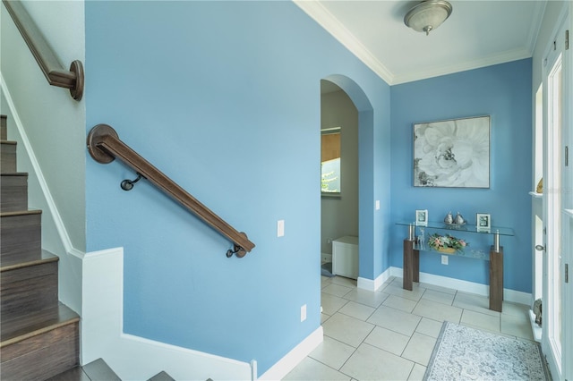 8268 Bellow St, Orlando, FL 32827 - staircase with ornamental molding, arched walkways, tile patterned flooring, and baseboards