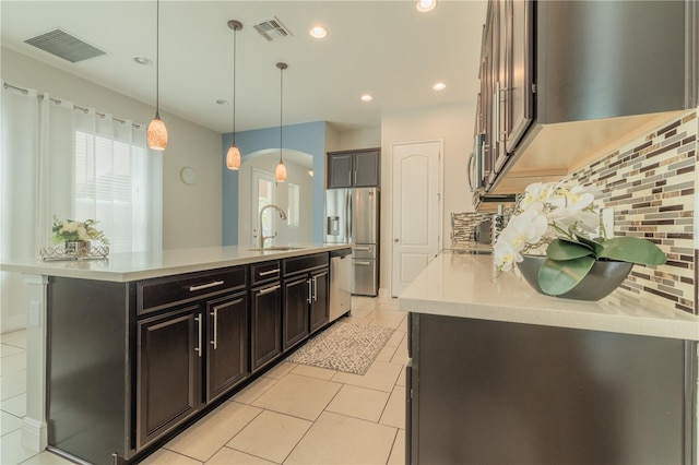 8268 Bellow St, Orlando, FL 32827 - kitchen with a sink, appliances with stainless steel finishes, light countertops, light tile patterned floors, and a kitchen island with sink