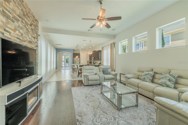 8268 Bellow St, Orlando, FL 32827 - living area with a ceiling fan, arched walkways, hardwood / wood-style floors, and a chandelier