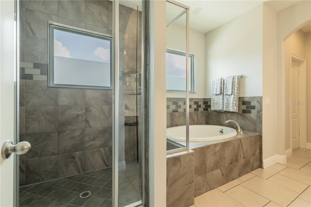 8268 Bellow St, Orlando, FL 32827 - bathroom featuring a stall shower, a bath, and tile patterned flooring