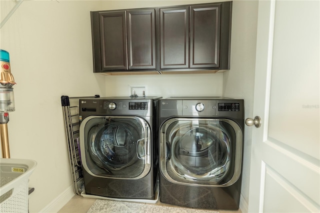 8268 Bellow St, Orlando, FL 32827 - washroom featuring washer and clothes dryer, cabinet space, and baseboards