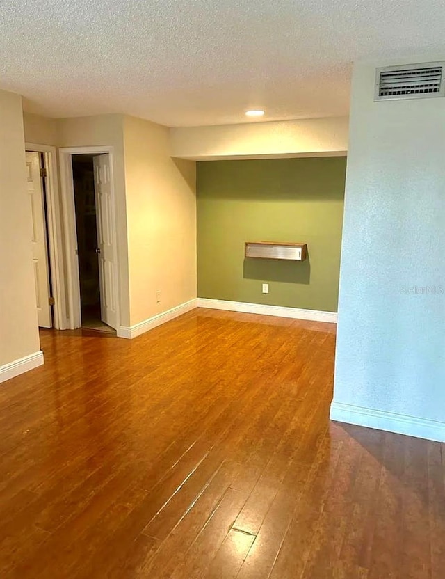 3772 Idlebrook Cir Unit 100, Casselberry, FL 32707 - unfurnished room with wood finished floors, baseboards, and a textured ceiling