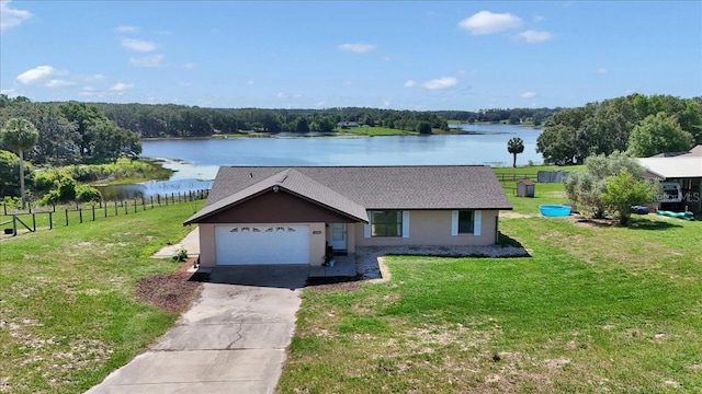 16386 SE 156th Place Rd, Weirsdale, FL 32195 - single story home featuring driveway, a water view, a garage, stucco siding, and a shingled roof