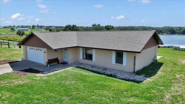 16386 SE 156th Place Rd, Weirsdale, FL 32195 - ranch-style house featuring stucco siding, driveway, roof with shingles, and a garage
