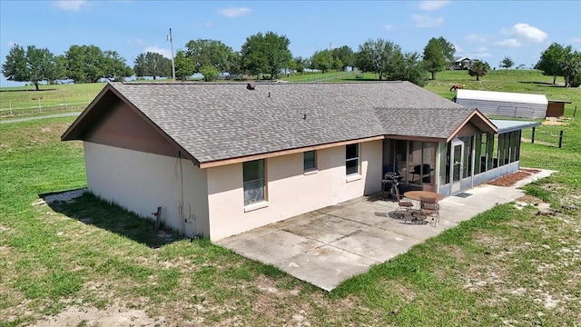 16386 SE 156th Place Rd, Weirsdale, FL 32195 - rear view of house featuring a shingled roof, stucco siding, a sunroom, a patio area, and a yard