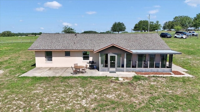 16386 SE 156th Place Rd, Weirsdale, FL 32195 - rear view of house featuring a sunroom, a patio, a lawn, and a shingled roof