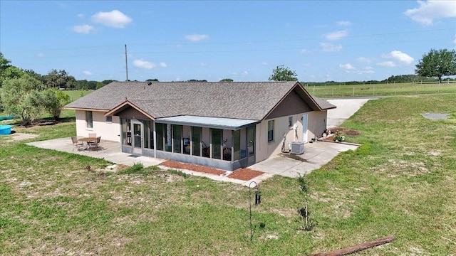 16386 SE 156th Place Rd, Weirsdale, FL 32195 - rear view of property with a sunroom, a patio area, and a yard