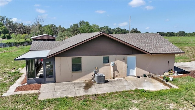 16386 SE 156th Place Rd, Weirsdale, FL 32195 - rear view of house with a lawn, a patio, a shingled roof, and cooling unit
