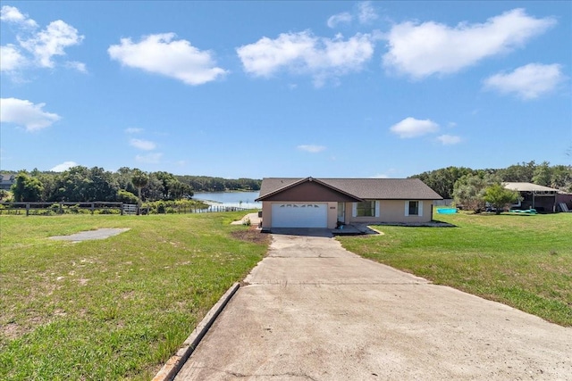 16386 SE 156th Place Rd, Weirsdale, FL 32195 - single story home with a water view, a garage, and driveway