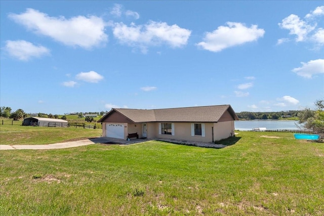 16386 SE 156th Place Rd, Weirsdale, FL 32195 - view of front of home featuring an attached garage, driveway, a water view, and stucco siding