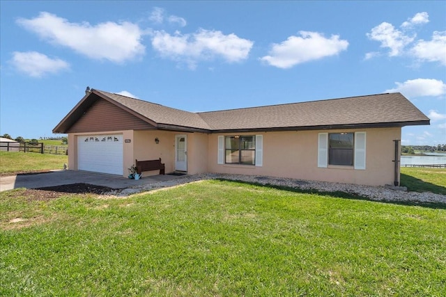 16386 SE 156th Place Rd, Weirsdale, FL 32195 - single story home with stucco siding, a garage, concrete driveway, and a water view