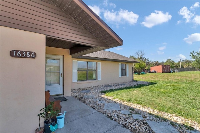 16386 SE 156th Place Rd, Weirsdale, FL 32195 - entrance to property featuring stucco siding and a lawn
